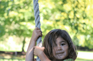 Child playing on swing outdoors