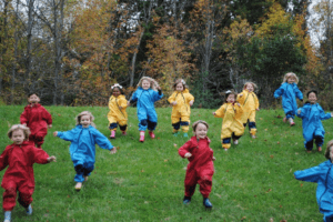 Group of children running down a hill. A risk benefit assessment form will help teachers plan learning outside the classroom.