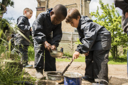 Children mixing mud outdoors